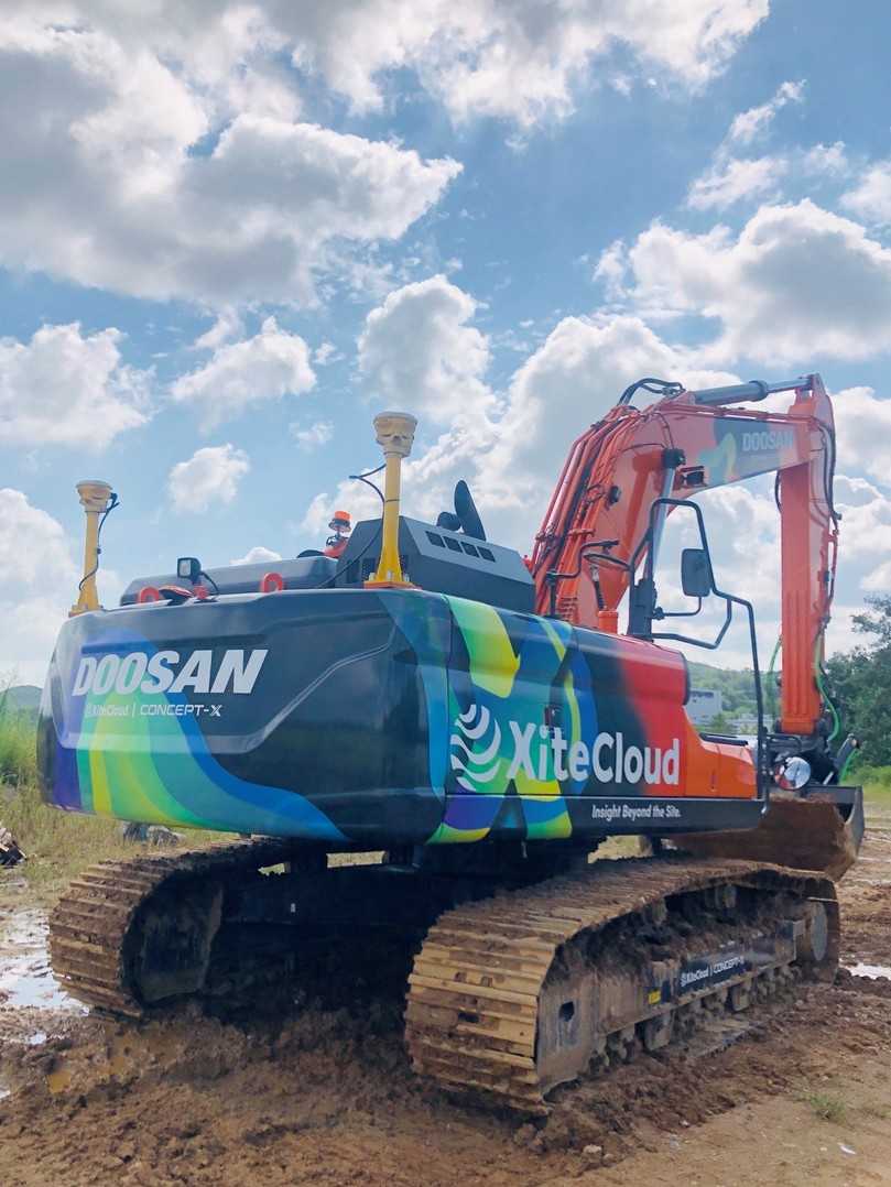 Doosan-Bagger als „Xitecloud-Werbeträger“ auf einer südkoreanischen Baustelle. Die GNSS-Antennen der 3D-Maschinensteuerung am Heck sind eine wichtige Voraussetzung für das datengetriebene Bauen. | Foto: Doosan Infracore Doosan-Bagger als „Xitecloud-Werbeträger“ auf einer südkoreanischen Baustelle. Die GNSS-Antennen der 3D-Maschinensteuerung am Heck sind eine wichtige Voraussetzung für das datengetriebene Bauen. | Foto: Doosan Infracore